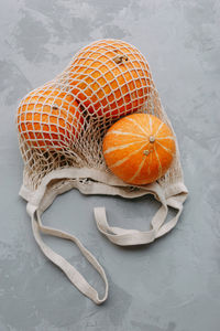 Mesh shopping bag with vegetables. autumn pumpkin harvest