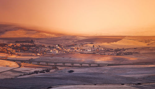 Aerial view of landscape against sky during sunset