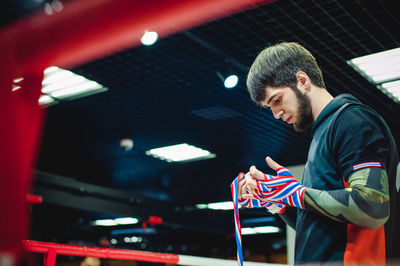 Thoughtful man standing in boxing ring