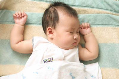 High angle view of baby sleeping in bed