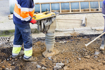 Low section of man working at construction site