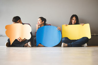 People sitting on wall