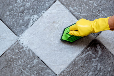 Midsection of person working with yellow umbrella