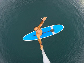 High angle view of man with boat in sea