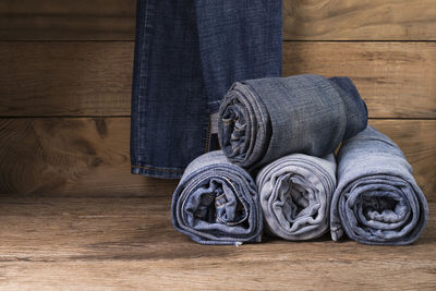 Stylish blue and black jeans. on a wooden table background.