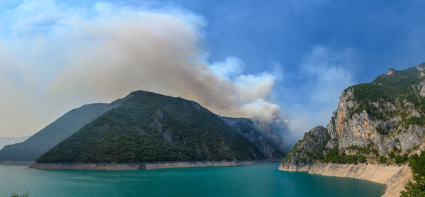 Panoramic view of sea and mountains against sky