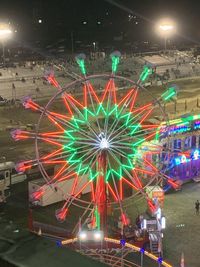 Illuminated ferris wheel at night