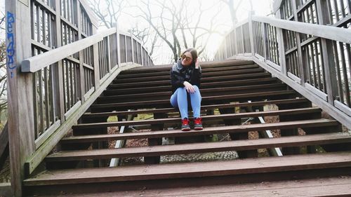 Full length portrait of woman on staircase