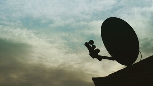 Low angle view of silhouette statue against sky