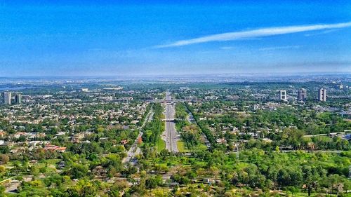 Aerial view of city against cloudy sky