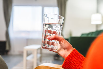 Cropped hand holding wineglass