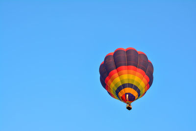 Low angle view of hot air balloon against blue sky