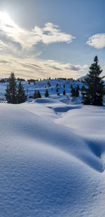 Scenic view of snow covered landscape against sky