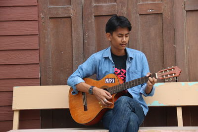 Full length of man playing guitar