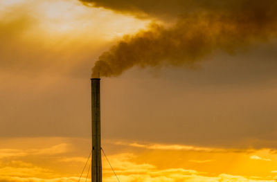 Air pollution from factory. smoke from chimney of industrial pipe on sunset sky. global warming.