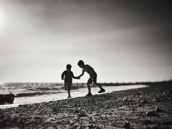 Full length of woman standing on beach