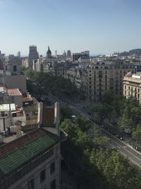 Buildings in city against blue sky