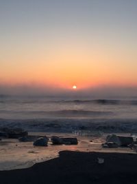 Scenic view of sea against clear sky during sunset