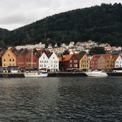 River by row houses against mountain