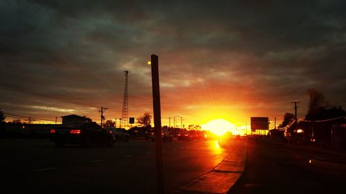 Cars on road at sunset