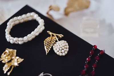 High angle view of jewelry on black board