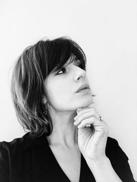 Close-up of young woman against white background