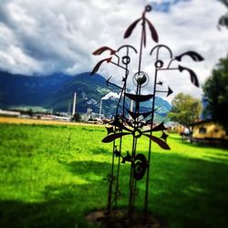 View of grassy field against cloudy sky