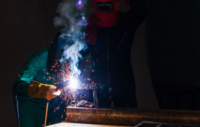 Man holding illuminated lighting equipment at night