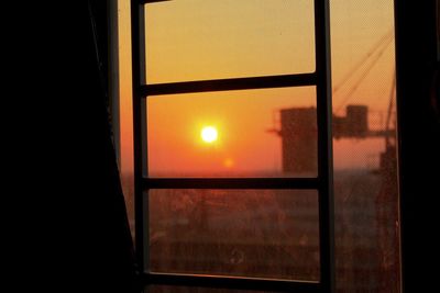 Close-up of window against sky during sunset