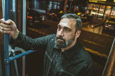 Handsome bearded man enters the tram or public transport. man on a bus/tram stop.