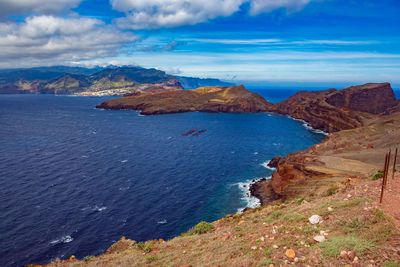 Scenic view of sea and mountains against sky