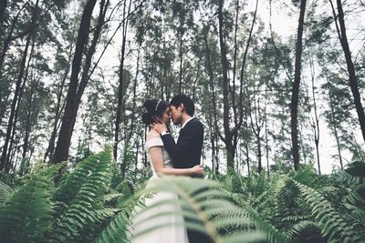 Young couple kissing in forest