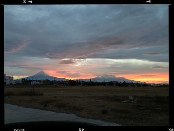 Scenic view of landscape against cloudy sky