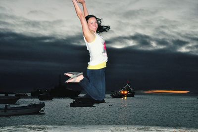 Woman looking at camera against sky