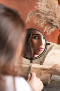 Reflection in the mirror of a beautiful young woman with dark hair. the concept of self-care