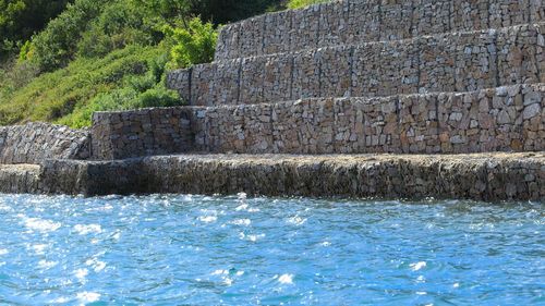 View of stone wall by swimming pool