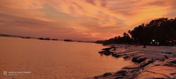 Scenic view of beach against sky during sunset