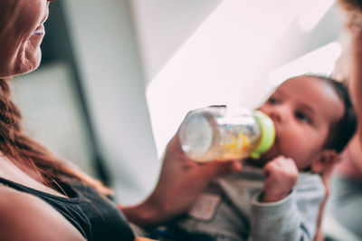 Portrait of woman drinking water from glass