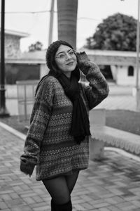 Portrait of a smiling young woman standing outdoors