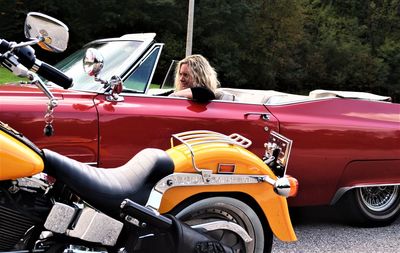 Side view of mature woman sitting in convertible