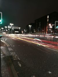 Illuminated city street at night