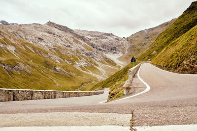 Road amidst mountains against sky