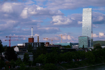 Modern buildings against cloudy sky