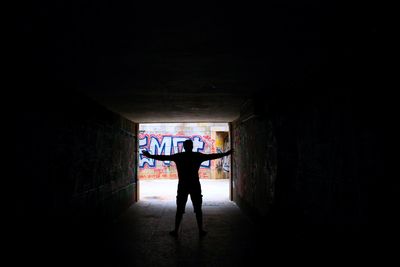 Silhouette man standing in corridor