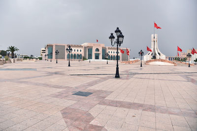 Built structure on footpath by buildings against sky