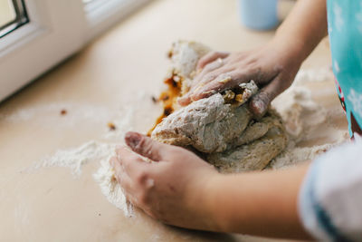 Close-up of woman preparing food on table