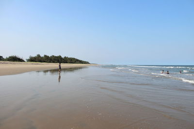 Scenic view of beach against clear sky