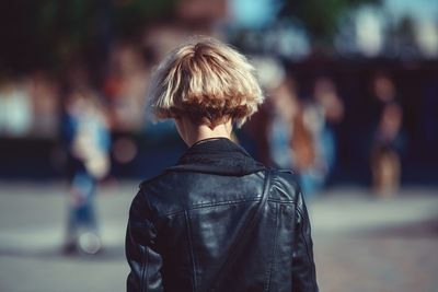 Rear view of woman walking on street in city