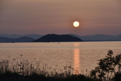 Scenic view of lake against sky during sunset