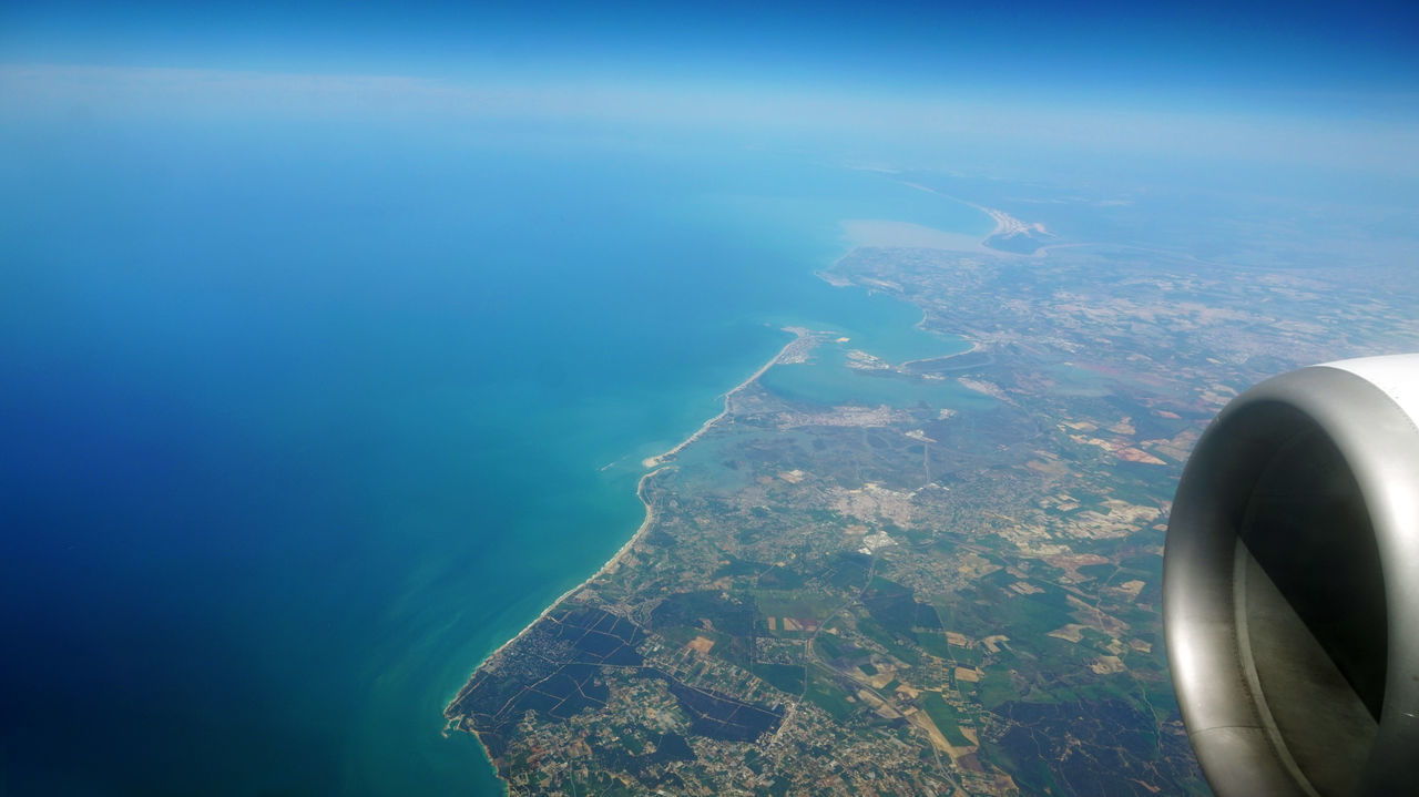 AERIAL VIEW OF AIRCRAFT WING OVER LANDSCAPE